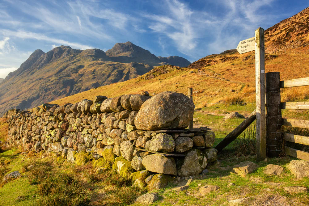 Langdale Pikes in Cumbria with fingerpost pointing to footpath